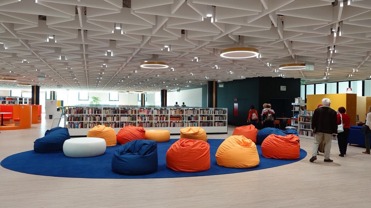 Students working in a university library reading room